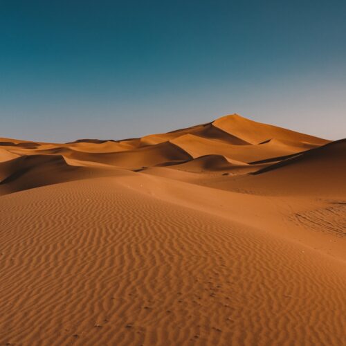 A beautiful view of tranquil desert under the clear sky captured in Morocco